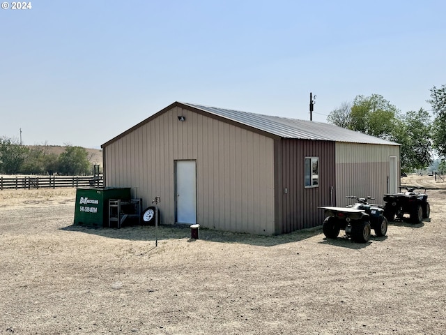 view of pole building featuring fence