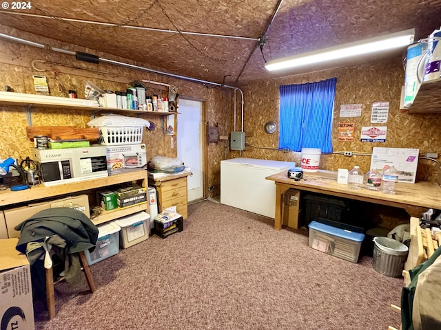 basement featuring carpet flooring and white fridge