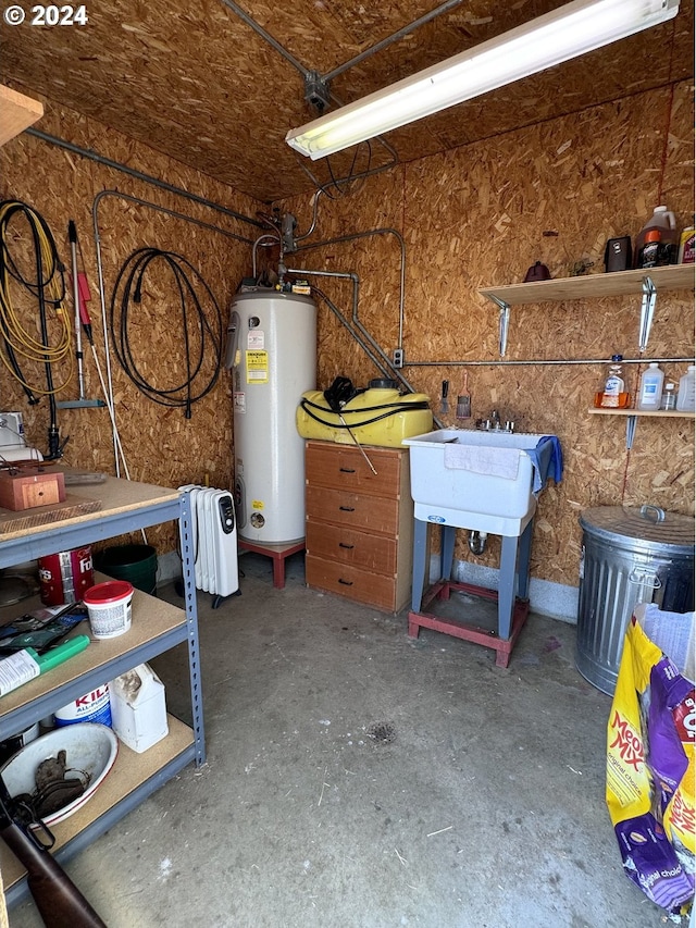 garage with water heater and a sink