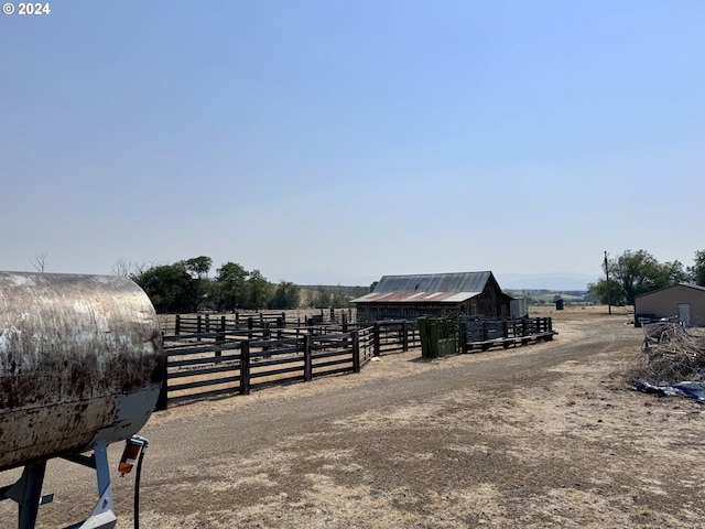 view of stable with a rural view