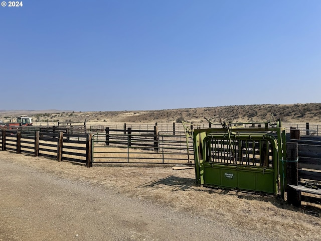 exterior space with fence and a rural view