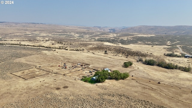 bird's eye view featuring a rural view, a desert view, and a mountain view