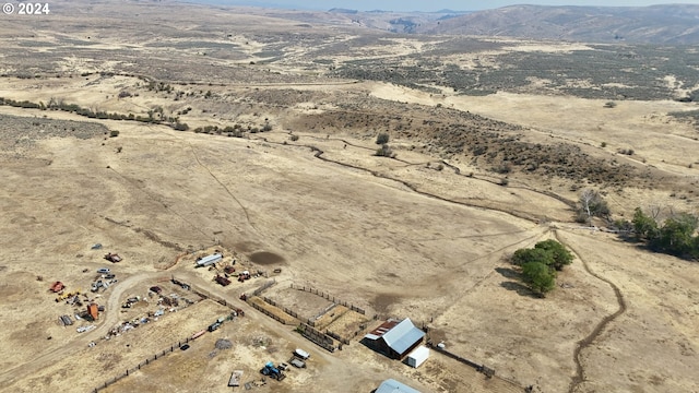 aerial view featuring view of desert and a mountain view