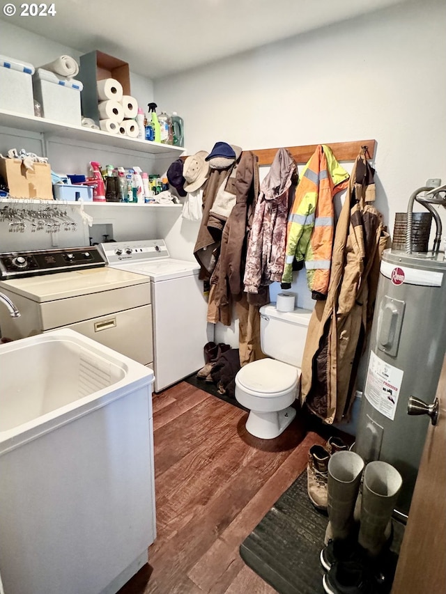 laundry area with laundry area, dark wood-type flooring, a sink, water heater, and washer and clothes dryer