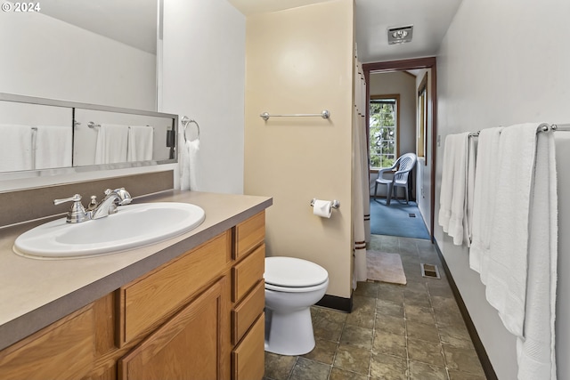 bathroom featuring vanity and toilet