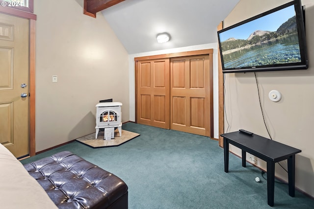 sitting room featuring carpet flooring, a wood stove, and vaulted ceiling with beams