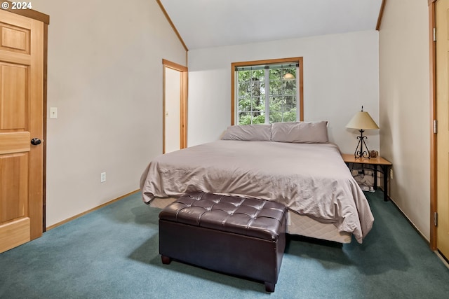 carpeted bedroom featuring lofted ceiling