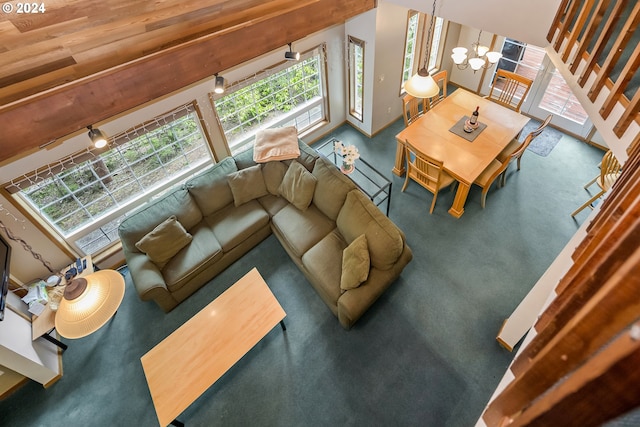 carpeted living room featuring wood ceiling, a chandelier, and vaulted ceiling