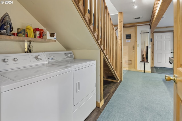 clothes washing area with dark hardwood / wood-style floors and washing machine and dryer