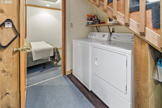 laundry room featuring washing machine and dryer and dark hardwood / wood-style floors