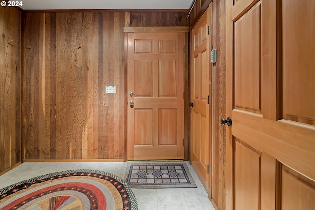 entryway featuring wooden walls