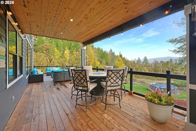 deck featuring an outdoor hangout area and a mountain view