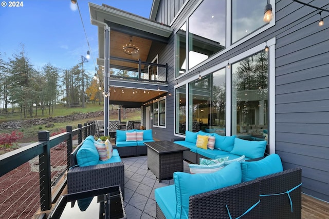 view of patio with outdoor lounge area and a balcony