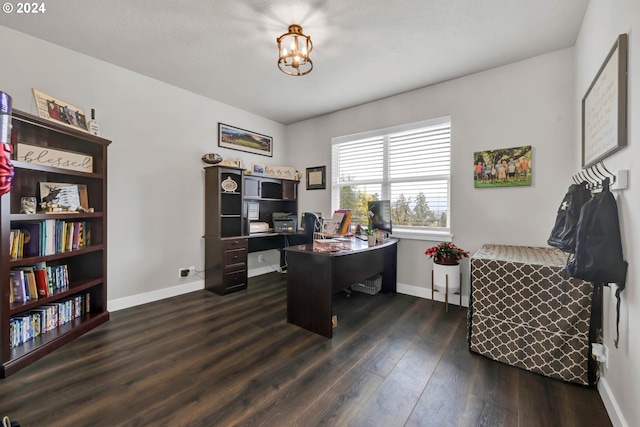 office space featuring dark wood-type flooring and a chandelier