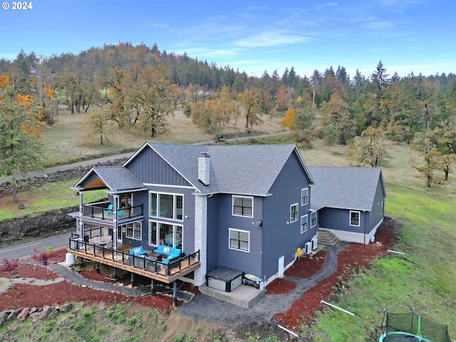 rear view of house featuring cooling unit and a deck