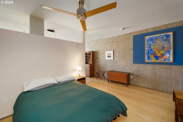 bedroom with ceiling fan and hardwood / wood-style floors