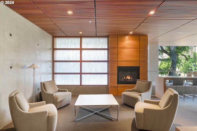 carpeted living room featuring a fireplace