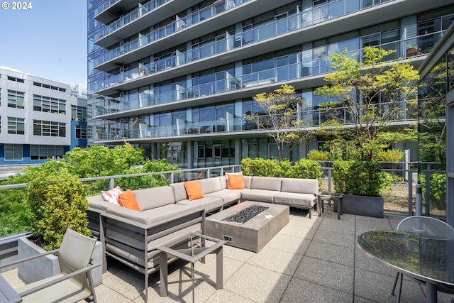 exterior space featuring an outdoor living space with a fire pit