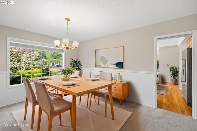 5393 SW Wichita St, Tualatin, OR 97062 - dining area featuring a chandelier, light carpet, and baseboards