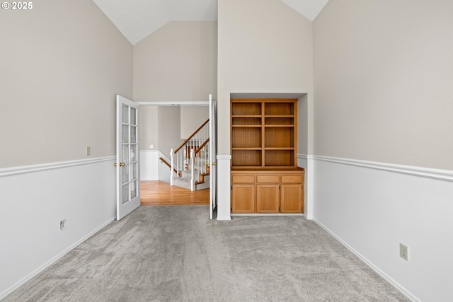 5393 SW Wichita St, Tualatin, OR 97062 - carpeted empty room featuring high vaulted ceiling, french doors, stairs, and baseboards
