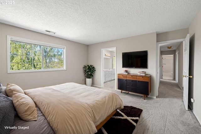 5393 SW Wichita St, Tualatin, OR 97062 - bedroom featuring light colored carpet, a textured ceiling, and ensuite bathroom