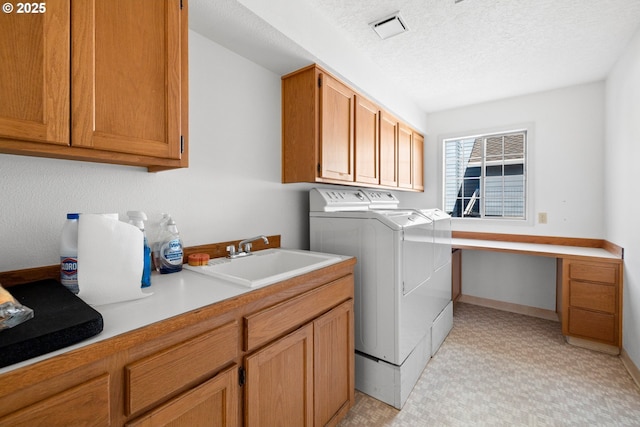 5393 SW Wichita St, Tualatin, OR 97062 - clothes washing area featuring independent washer and dryer, light flooring, cabinet space, a desk, and a textured ceiling