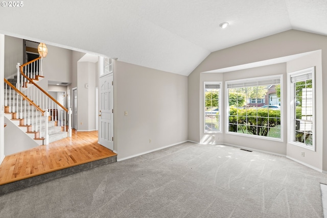 5393 SW Wichita St, Tualatin, OR 97062 - unfurnished living room with vaulted ceiling, carpet flooring, baseboards, and stairway