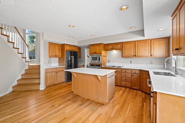 5393 SW Wichita St, Tualatin, OR 97062 - kitchen featuring black appliances, a sink, light wood finished floors, plenty of natural light, and recessed lighting