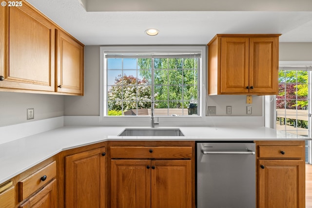 5393 SW Wichita St, Tualatin, OR 97062 - kitchen with stainless steel dishwasher, light countertops, a sink, brown cabinets, and recessed lighting
