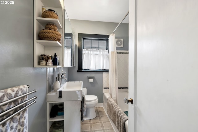 full bathroom with toilet, sink, tile walls, and shower / bath combo