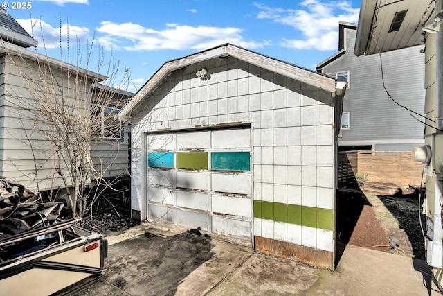 view of side of home with a garage and an outbuilding