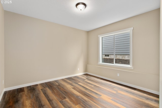 144 E H St, Vernonia, OR 97064 - spare room with dark wood-style flooring and baseboards