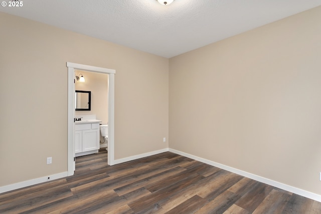 144 E H St, Vernonia, OR 97064 - spare room featuring baseboards and dark wood-style flooring