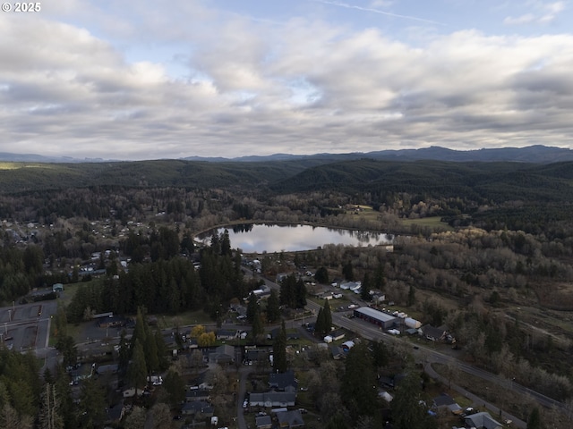 144 E H St, Vernonia, OR 97064 - aerial view of property and surrounding area featuring a water and mountain view and a heavily wooded area