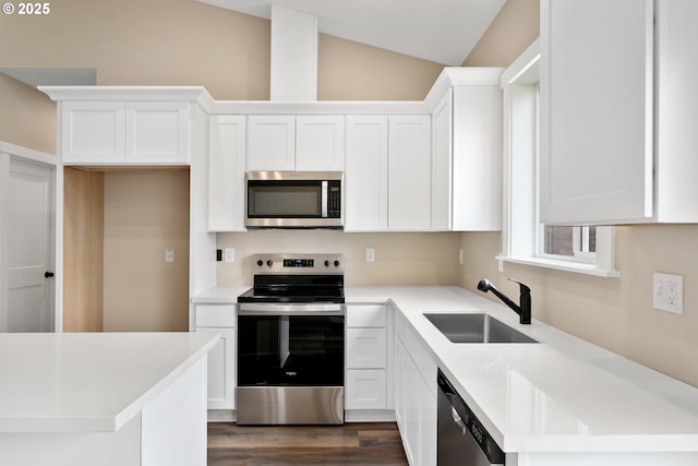 144 E H St, Vernonia, OR 97064 - kitchen with stainless steel appliances, a sink, lofted ceiling, and white cabinetry