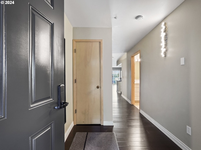 corridor featuring dark hardwood / wood-style flooring