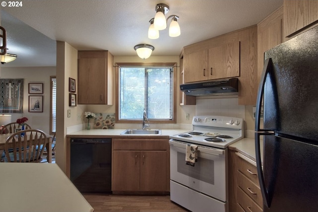 kitchen with sink, black appliances, a textured ceiling, light hardwood / wood-style floors, and backsplash