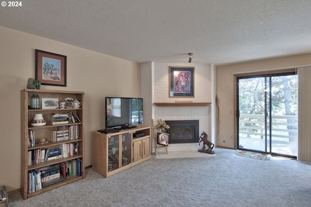 carpeted living room with a brick fireplace and a textured ceiling