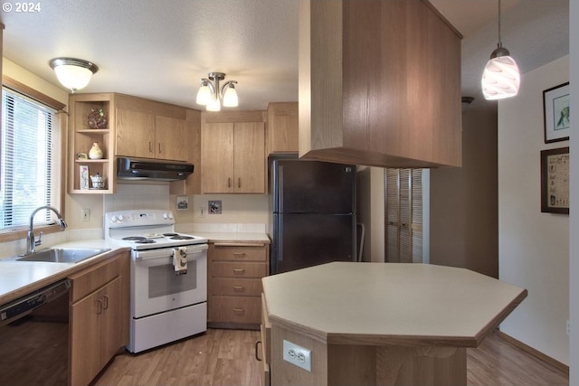 kitchen featuring pendant lighting, sink, a notable chandelier, black appliances, and light wood-type flooring