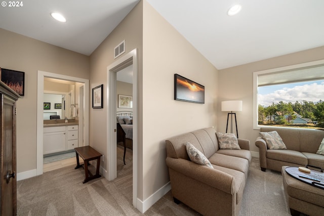 carpeted living room with vaulted ceiling