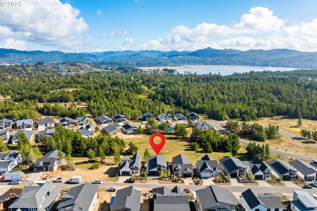 bird's eye view with a water and mountain view