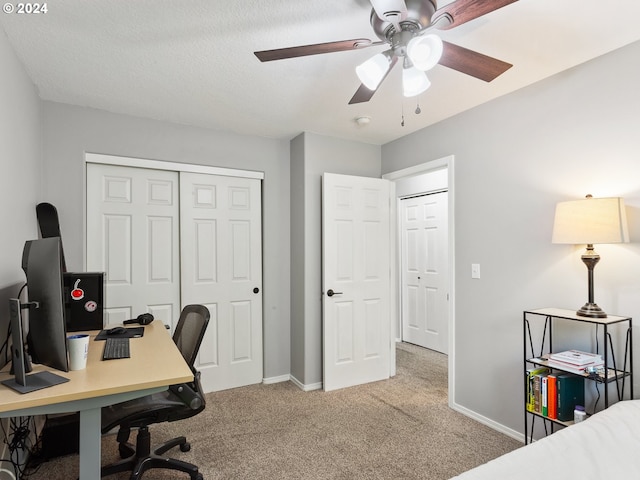 office with a textured ceiling, ceiling fan, and light colored carpet