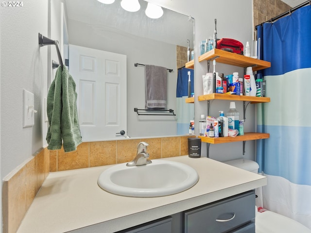 bathroom featuring toilet and vanity