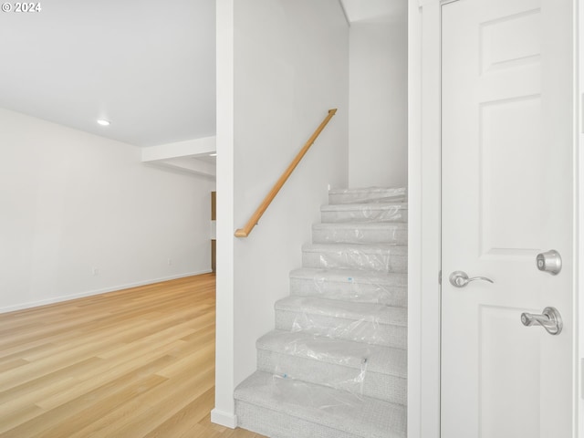 stairs with wood-type flooring