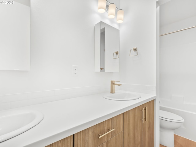 full bathroom featuring vanity, hardwood / wood-style floors, toilet, and shower / bathtub combination