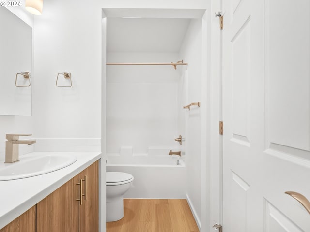 full bathroom featuring vanity, hardwood / wood-style floors, shower / tub combination, and toilet