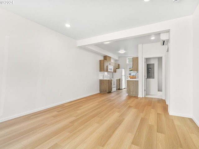 unfurnished living room with light hardwood / wood-style floors and electric panel