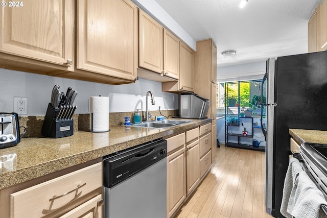 kitchen featuring dishwasher, light hardwood / wood-style floors, sink, and light brown cabinetry