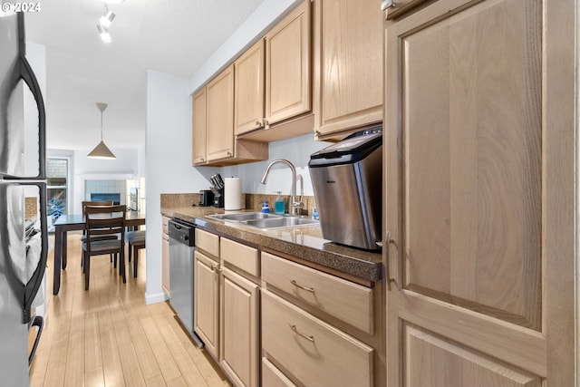 kitchen featuring light brown cabinets, light wood-type flooring, sink, and appliances with stainless steel finishes