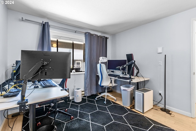 home office with hardwood / wood-style flooring